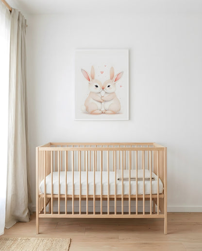 Nursery Sibling Bunnies Soft Watercolour Printable Wall Art — framed above a crib in a softly lit nursery