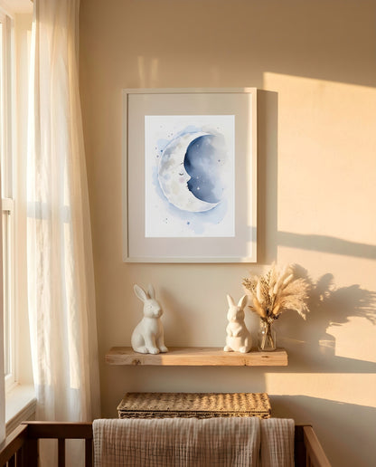 Nursery Sleeping Moon Minimal Watercolor Printable Wall Art — framed in white on a neutral wall