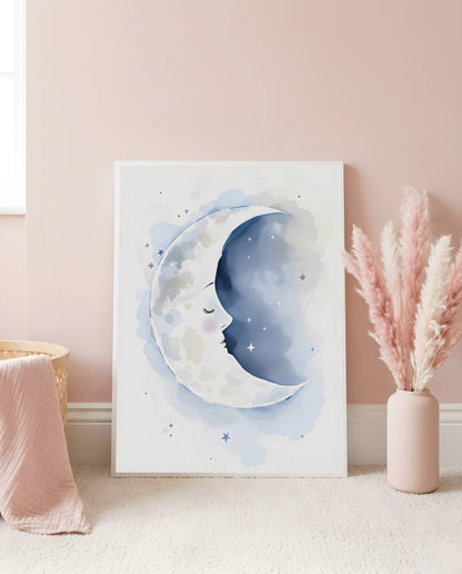 Nursery Sleeping Moon Minimal Watercolor Printable Wall Art — leaning against a light wall in a styled setting